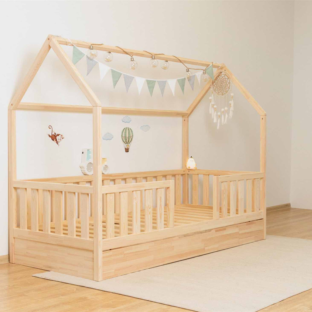 Hausbett Roko mit mittigem Einstieg & Ausziehbett aus FSC-zertifiziertem Kiefernholz in Natur mit Rausfallschutz und praktischem Zusatzbettkasten.