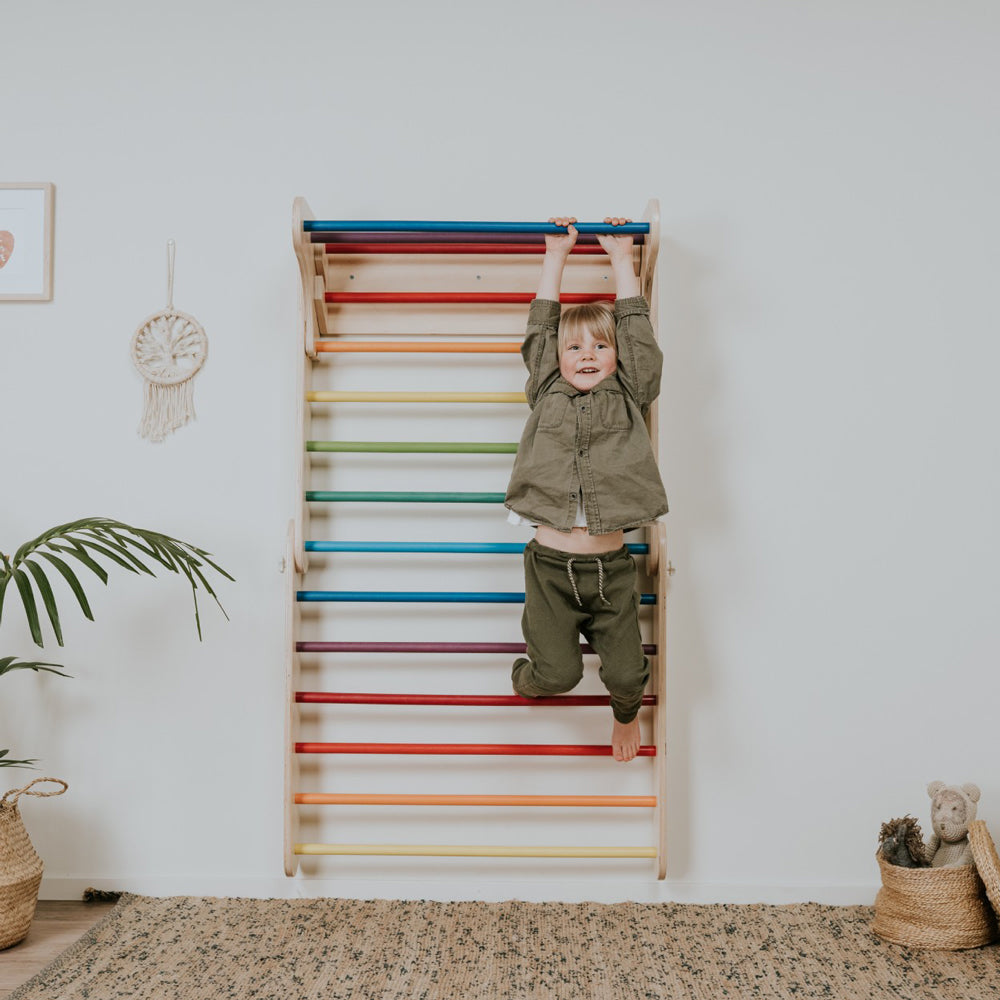 Kind klettert an farbiger Holz-Sprossenwand im skandinavischen Stil, fördert spielerisch Motorik und Bewegungslust im Kinderzimmer.
